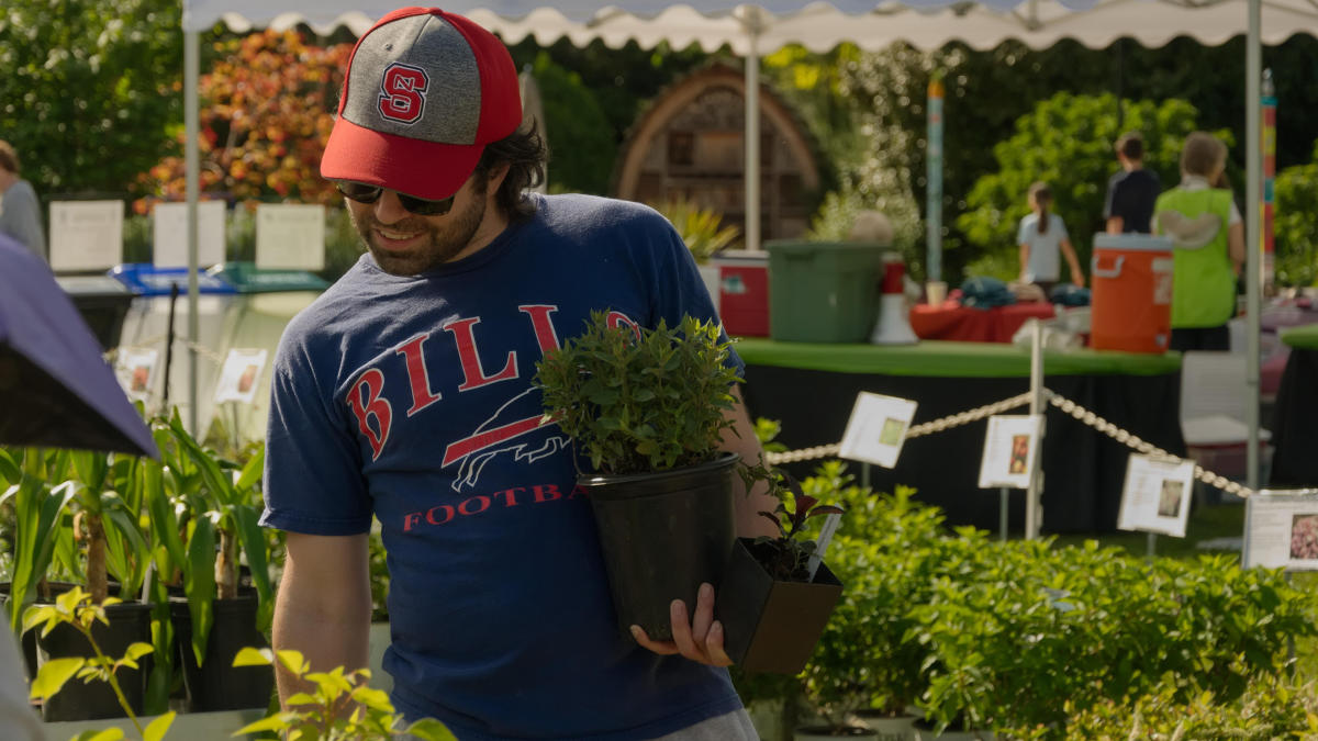 Attendees exploring a wide variety of plants at the Gardening 101 event in Raleigh, NC.